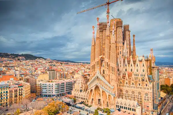 Explore La Sagrada Familia on tour with Classic Journeys A view of the Barcelona skyline behind La Sagrada Familia