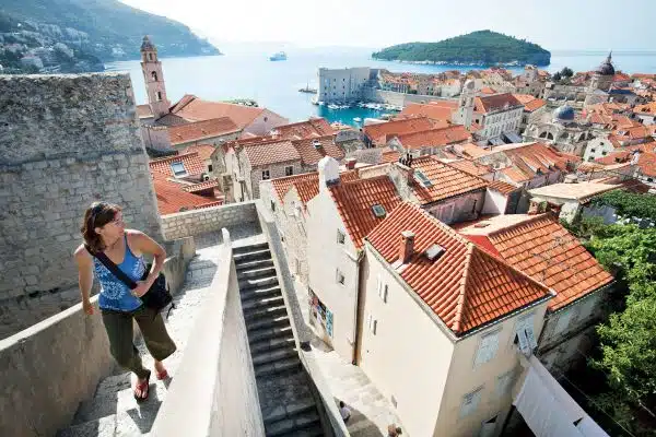 Woman walking up stairs in Croatia