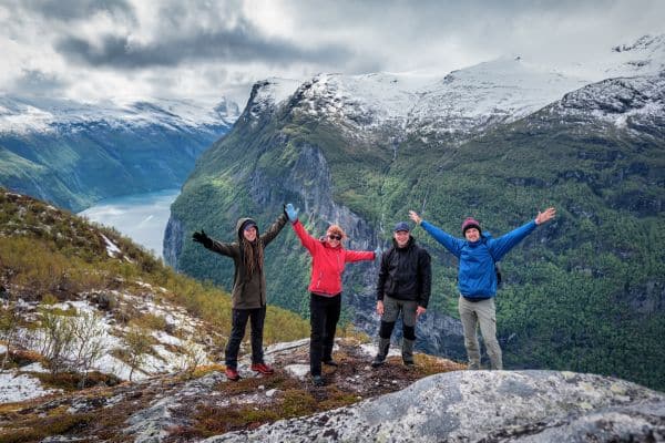 Group of travelers in front of mountains in Norway