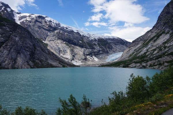 Beautiful views of Jostedal Valley Lake in Norway, surrounded by mountains on all sides