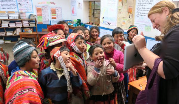 Guest showing Peruvian students her ipad on tour