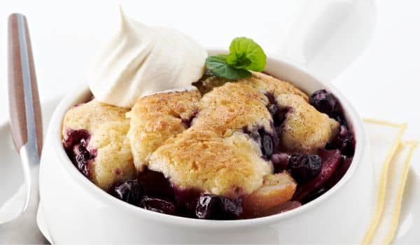 Huckleberry cobbler in a white dish