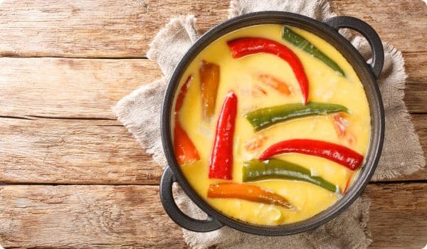 Bowl of Ema Datshi with spicy peppers