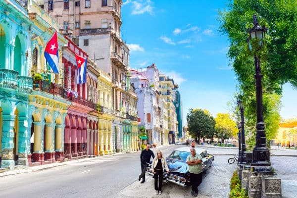 Havana street life in Cuba with locals and classic cars