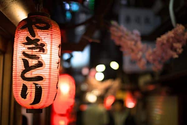 Japanese lantern glowing along a city street at night