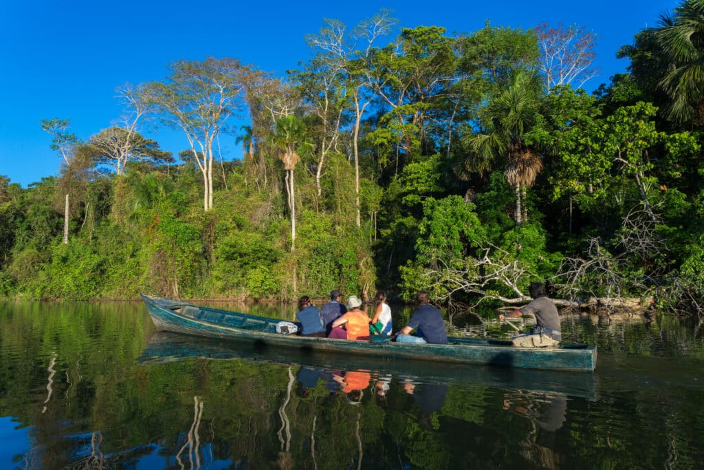 Travelers exploring the Peruvian Amazon by canoe