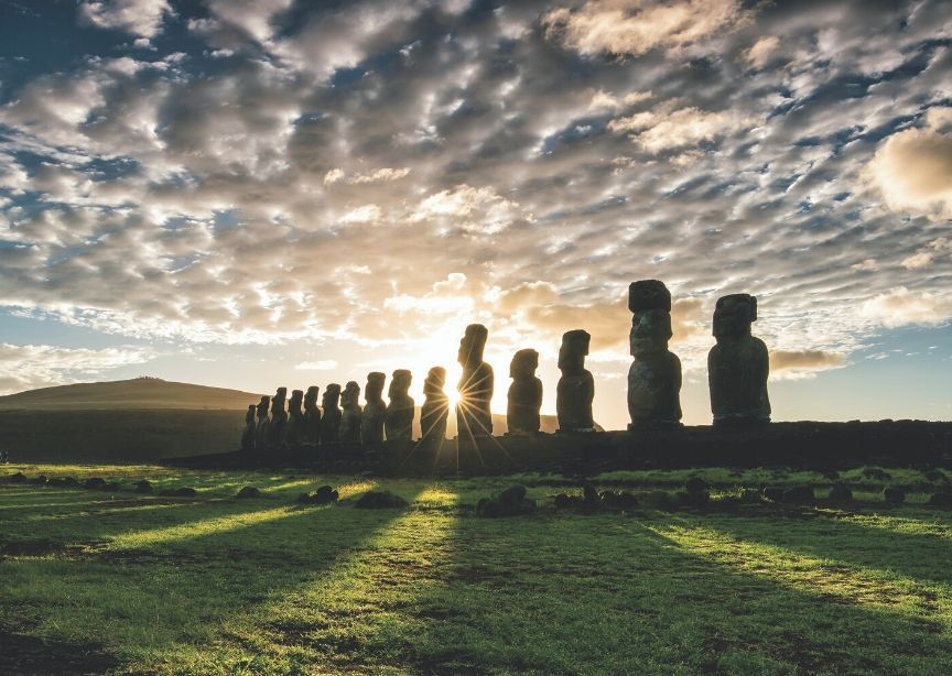 Chile Easter Island moai statues sun rays shining through