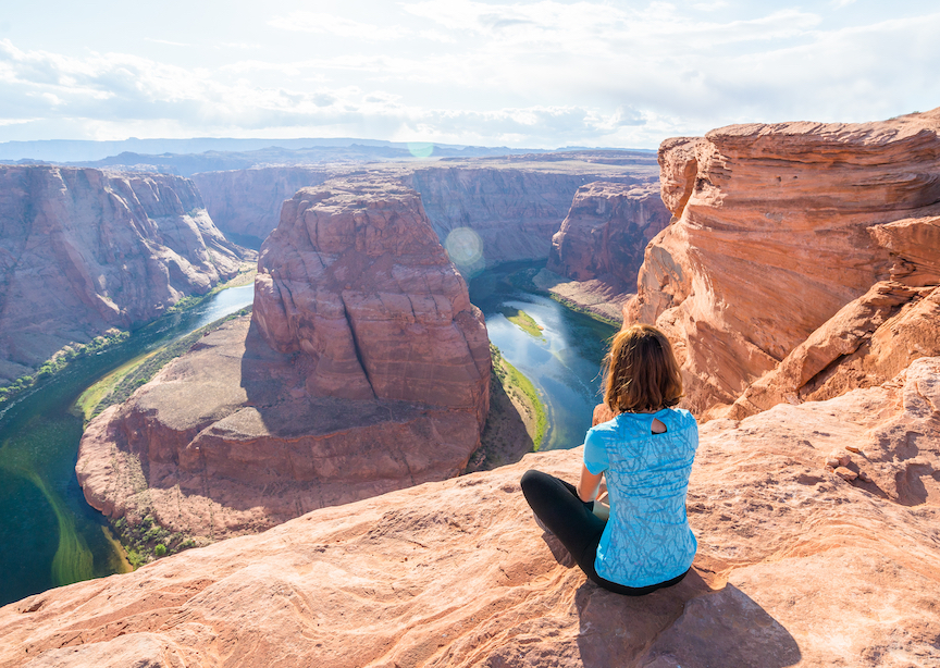 Grand Canyon US National Park Expert Local Female Guide Marcia admiring the view of the river & canyons