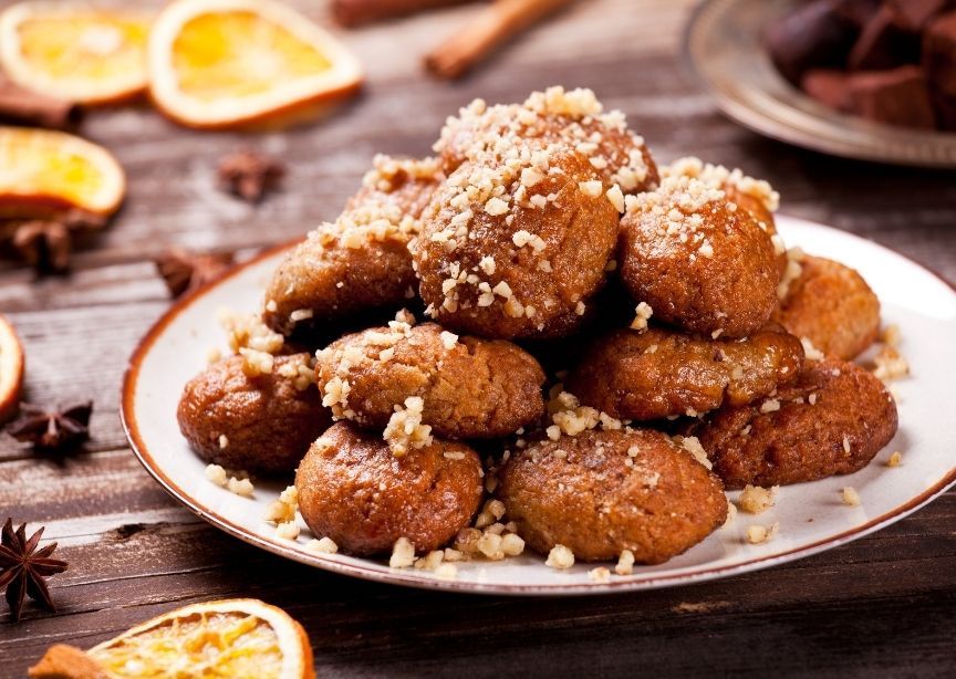 Greek Melomakarona Christmas Cookies on Plate with Candied Orange