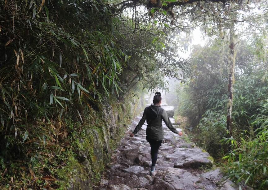 Female traveler walking down Inca Trail in Peru