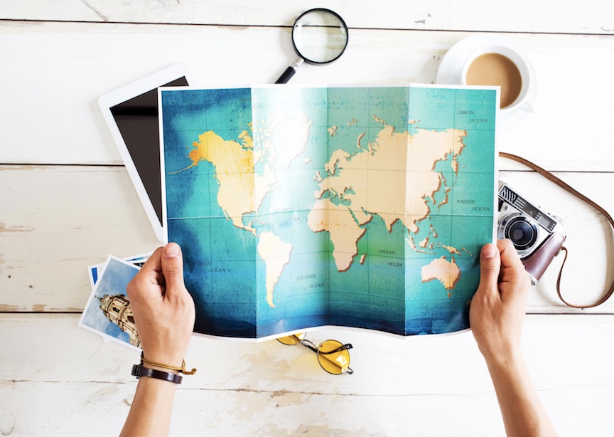 Person planning their travel, with hands holding a map