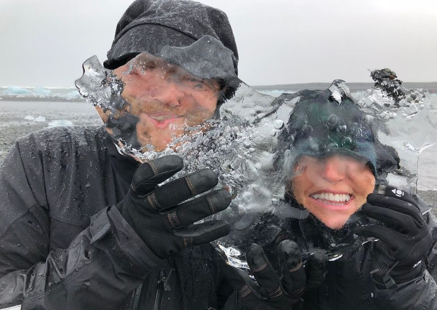 Iceland guide and guest smiling with ice on glacier