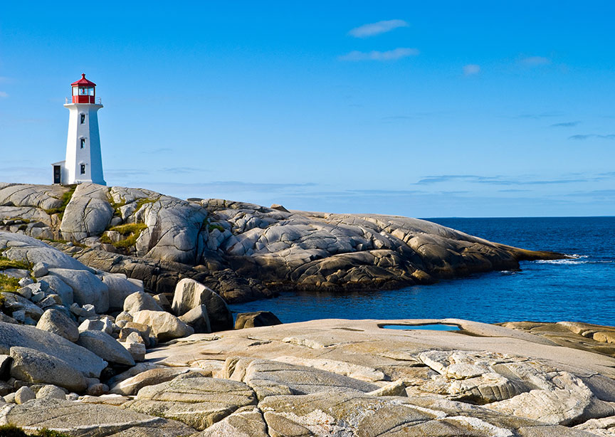 Canada Nova Scotia lighthouse on headland blue skies